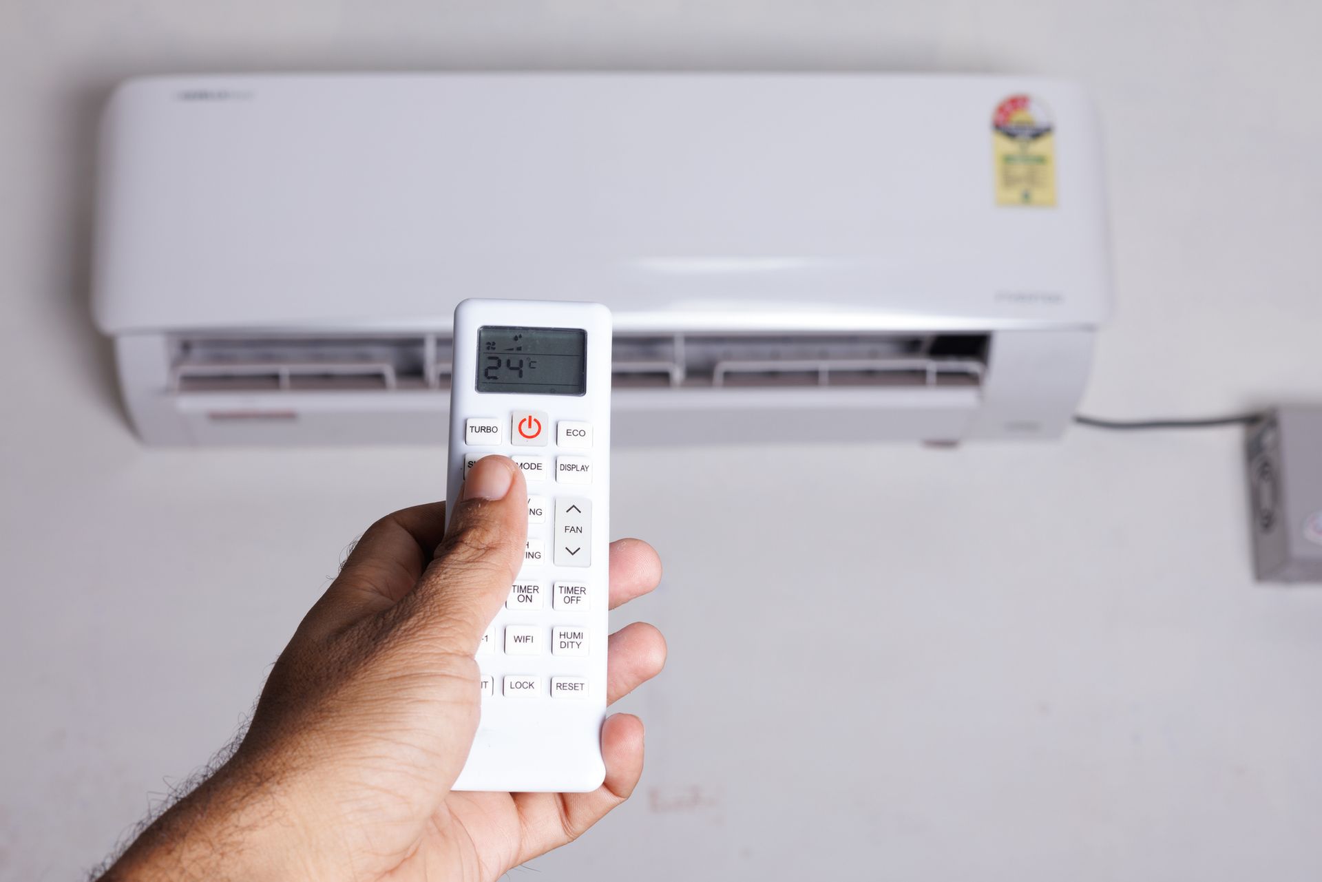 Two men are working on an air conditioner outside of a brick building. Two men are working on an air conditioner outside of a brick building.