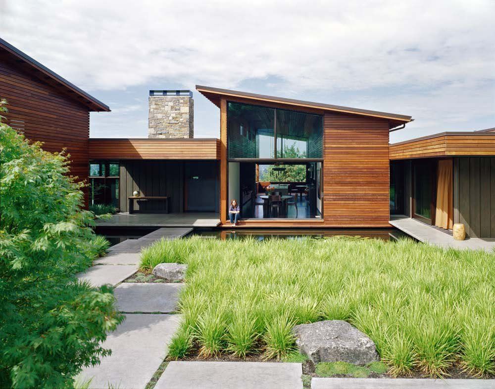 A house with a lot of windows and a walkway leading to it