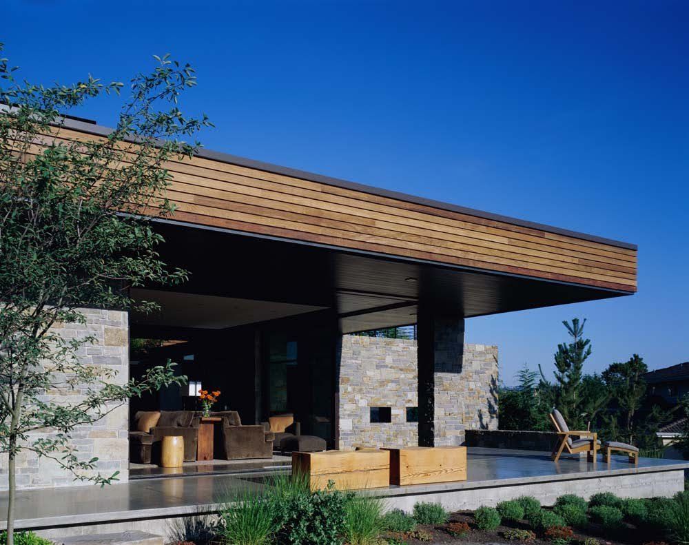 A house with a wooden roof and a patio