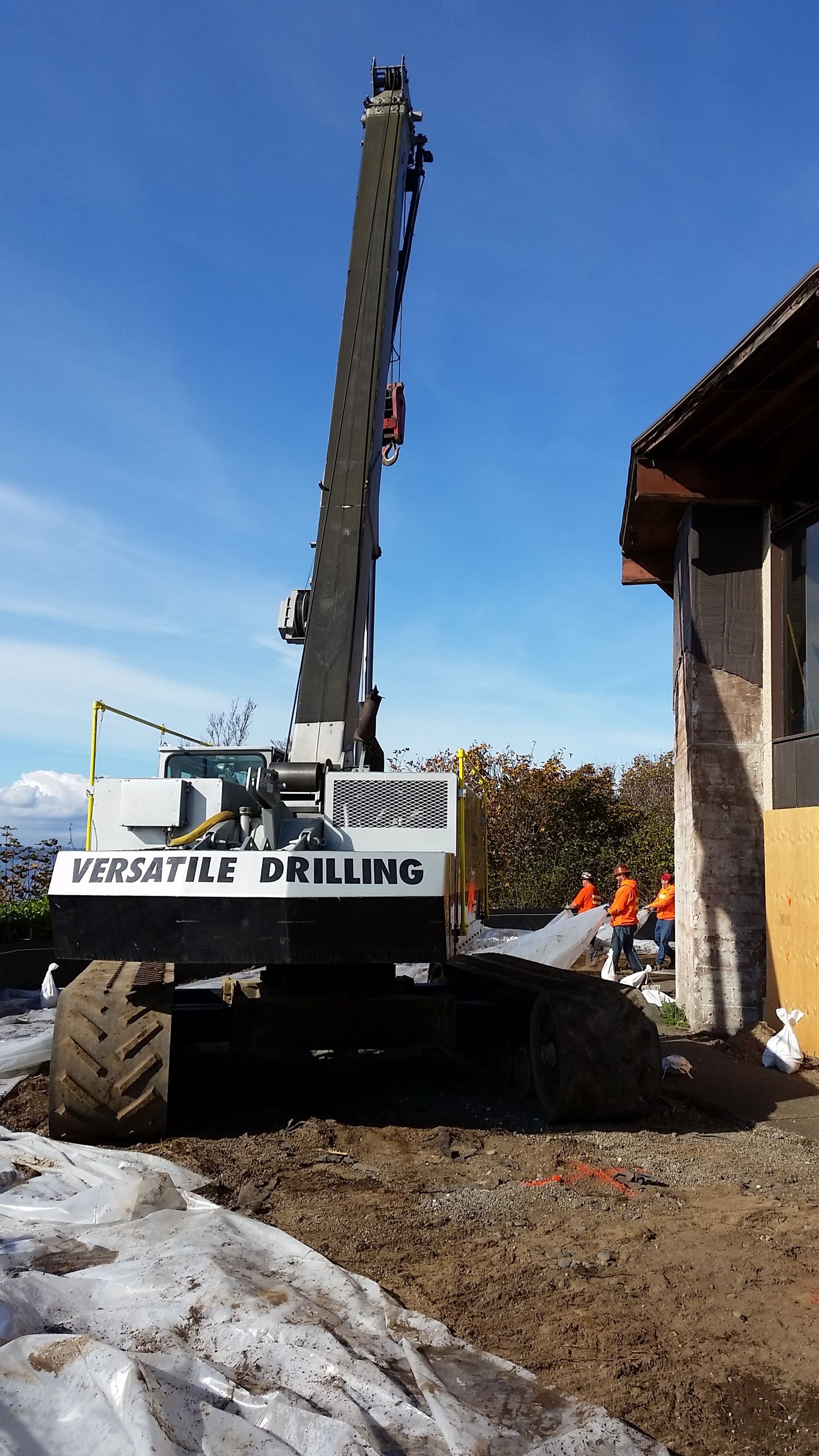 A large crane is sitting in front of a building.