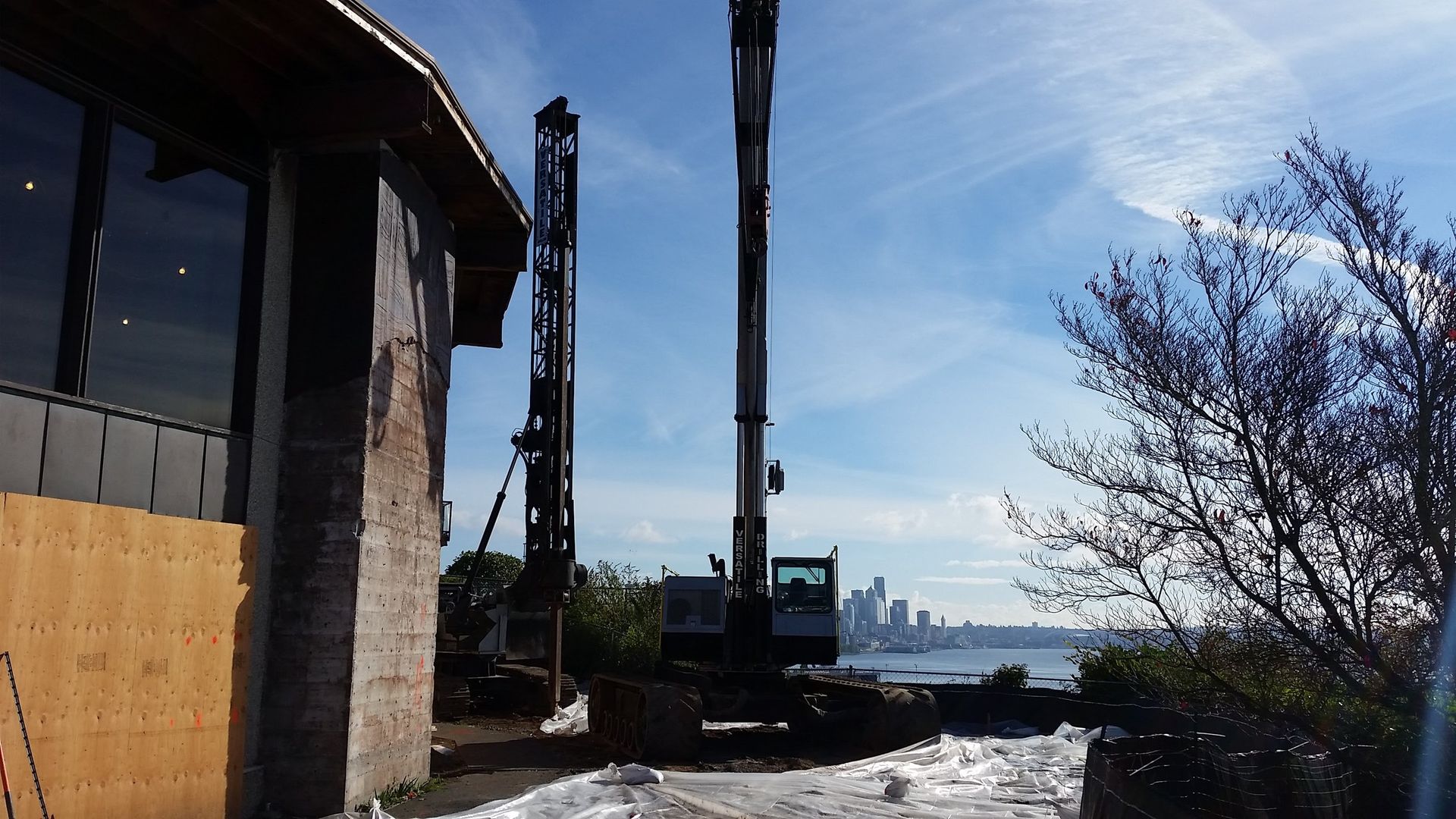 A large crane is sitting in front of a building