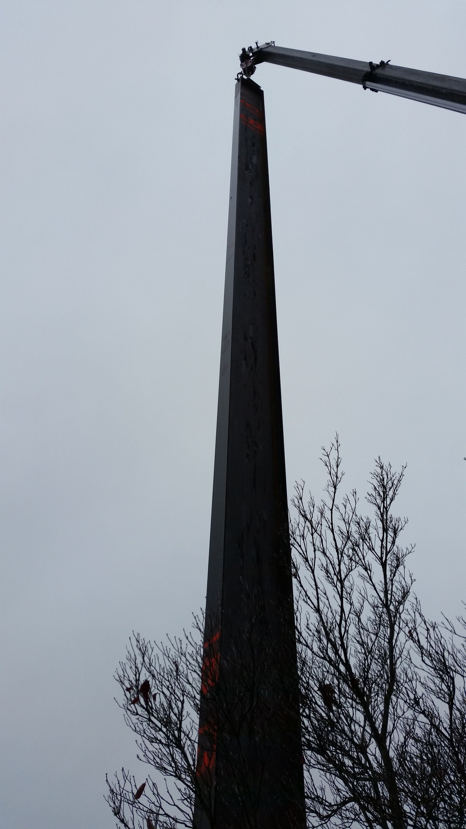 A tall tower with a crane attached to it