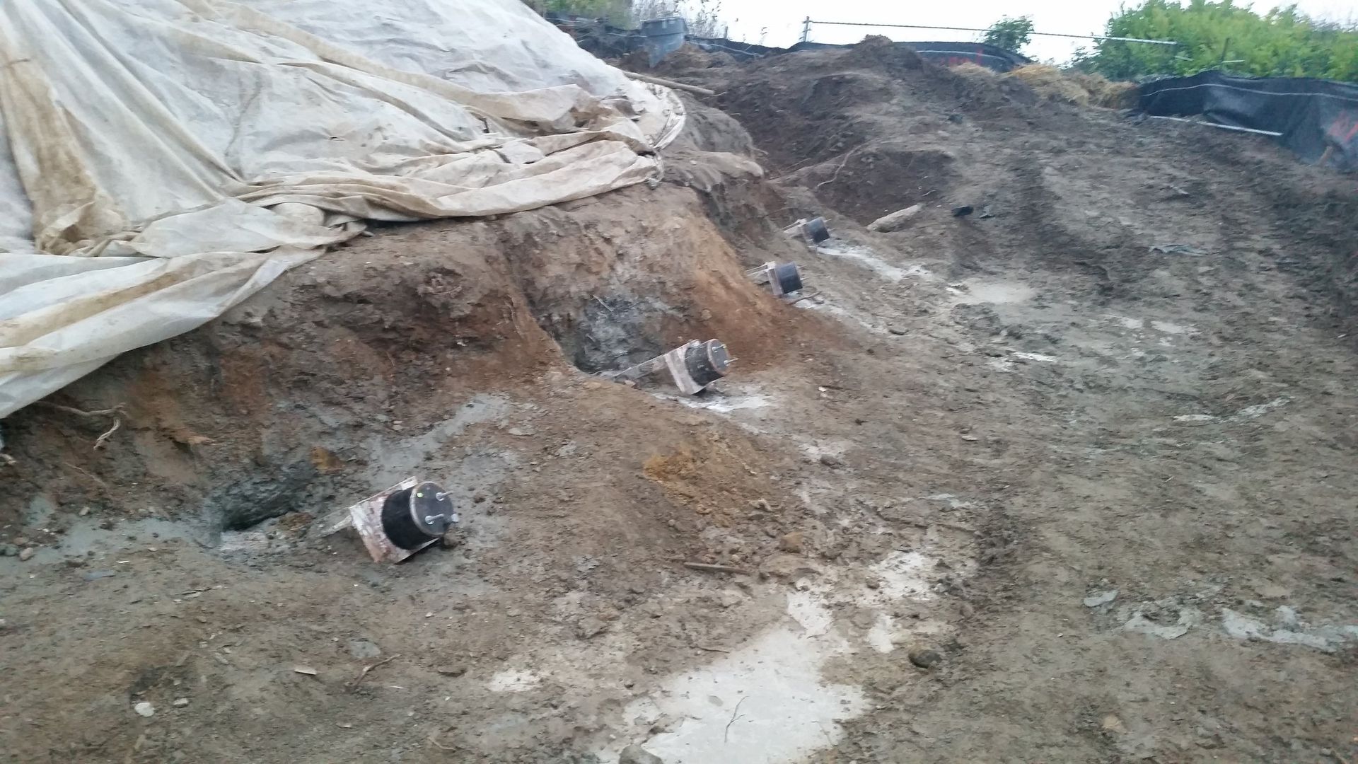 A large pile of dirt is sitting on top of a dirt hill.