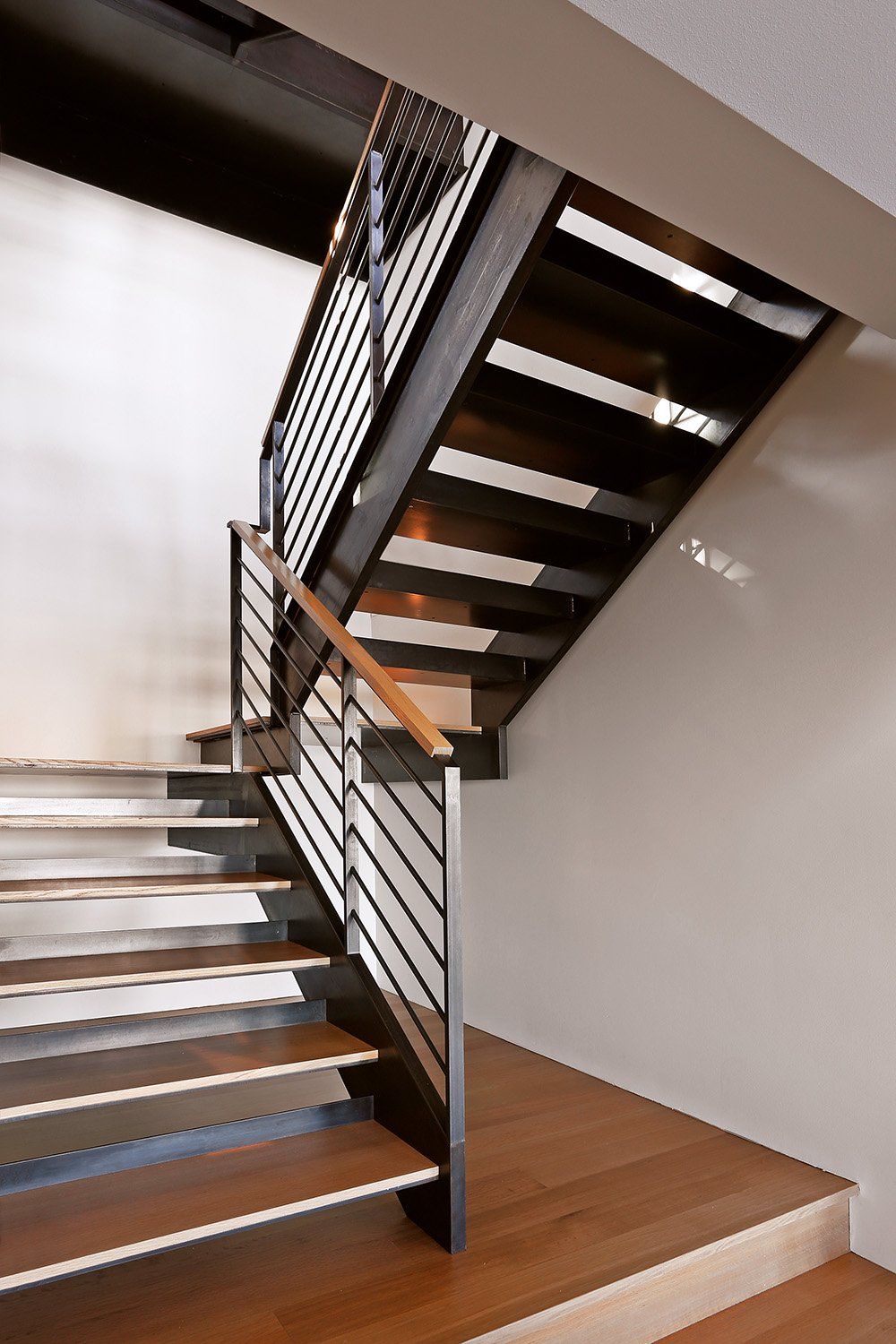 A staircase with wooden steps and a metal railing