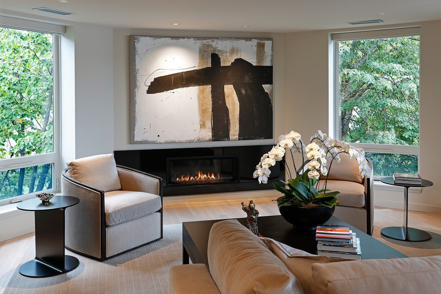 A living room with a fireplace and a painting on the wall