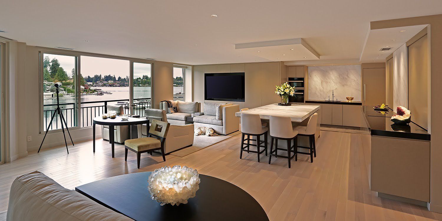 A living room with a couch , table , chairs and a television.