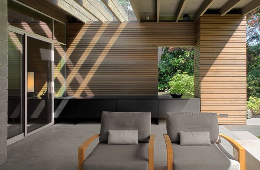 A patio with two chairs and a couch in a house