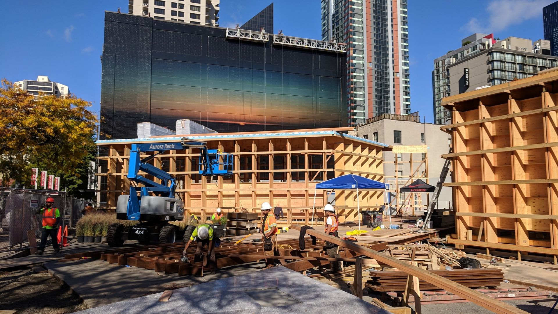 A construction site with a large billboard in the background.