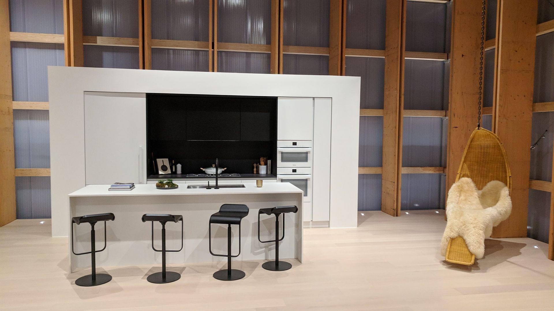 A kitchen with a large flat screen tv on the wall