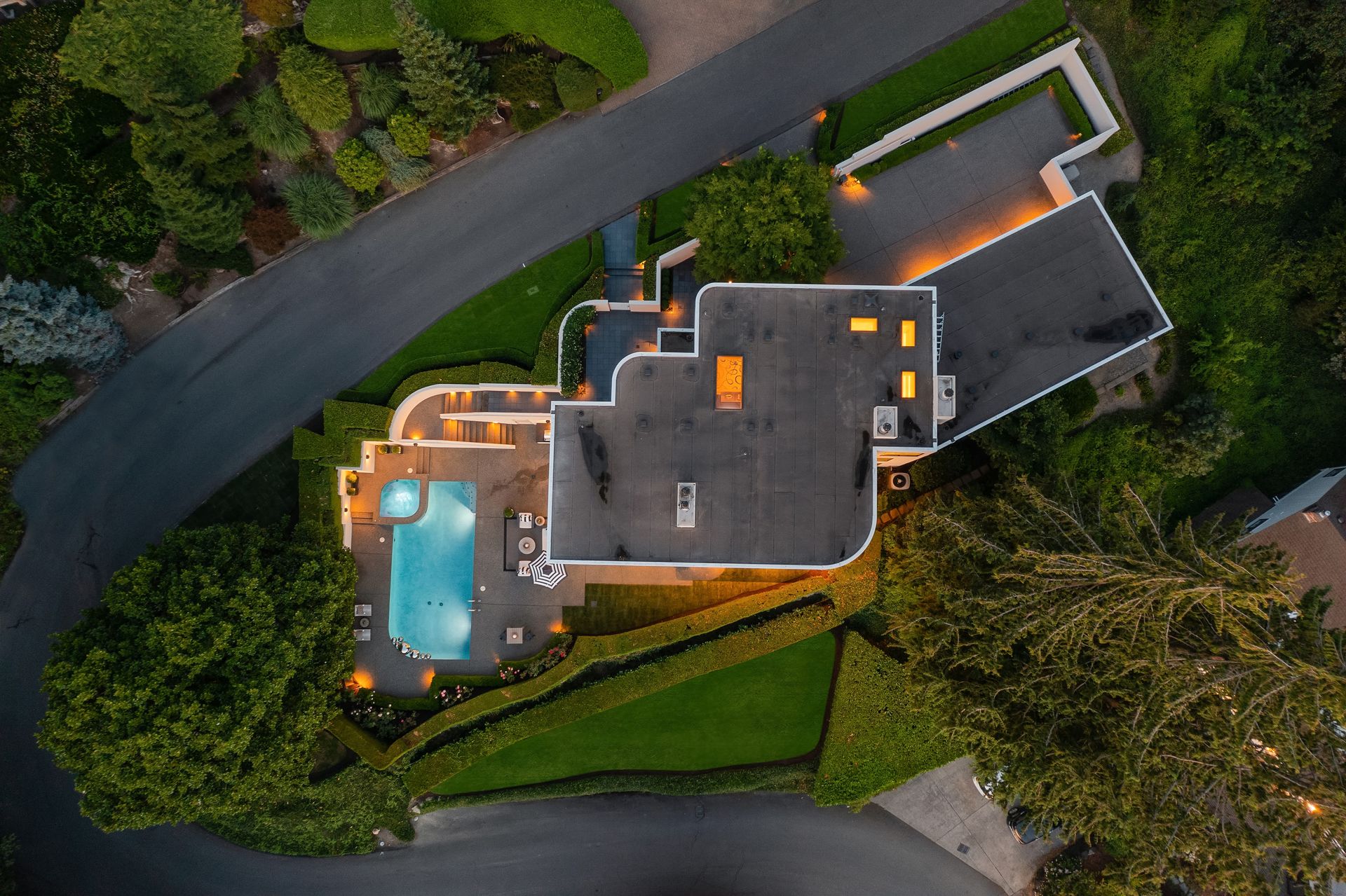 An aerial view of a large house with a pool in the backyard.