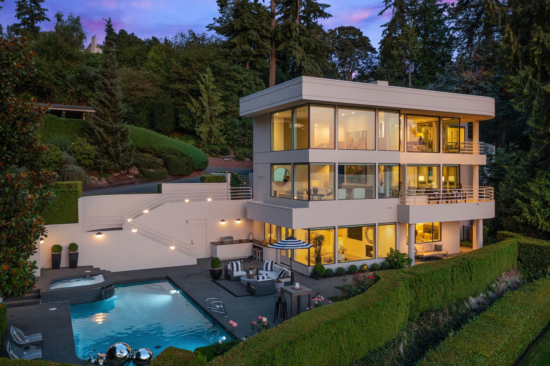 A large house with a swimming pool in front of it