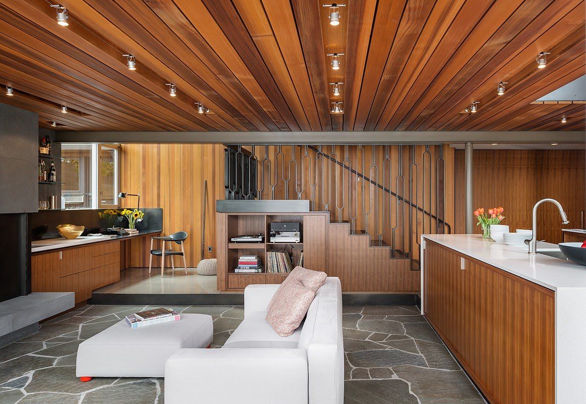 A living room with a wooden ceiling and a white couch