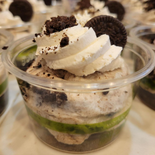 Cookies & cream dessert cup with green lid label on a red background