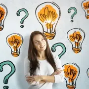 Woman standing with arms crossed, looking up, surrounded by orange lightbulb icons and teal question marks