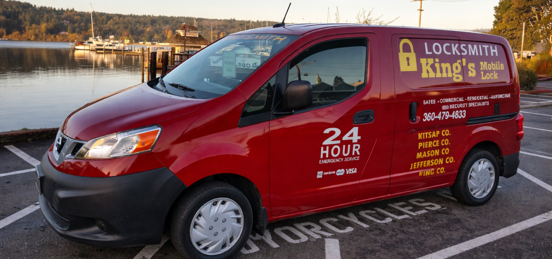 A red King’s Mobile Locksmith van parked in an outdoor lot near a body of water during sunset.