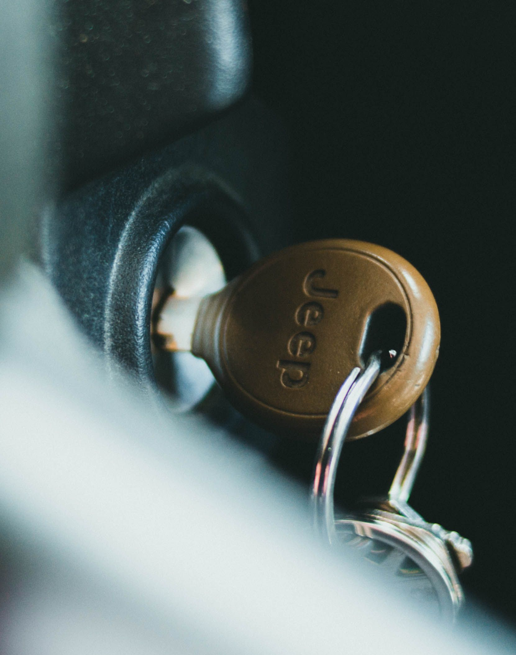 Jeep car key inserted in ignition, close-up with key ring