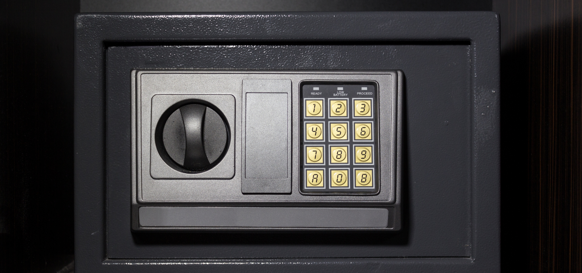 A hand using a power drill to install or secure a square, chrome-finished door handle onto a white door.