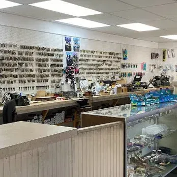 Inside a locksmith shop with keys on display, tools, and a service counter.
