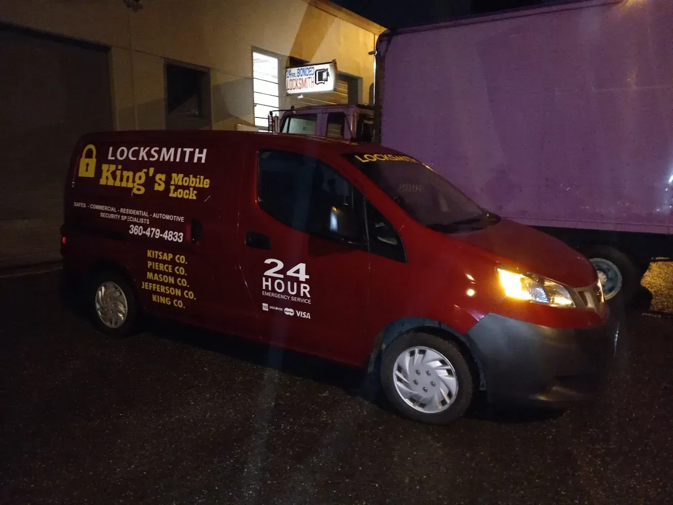 Red King's Locksmith van, 24-hour mobile service, parked outside a building at night.