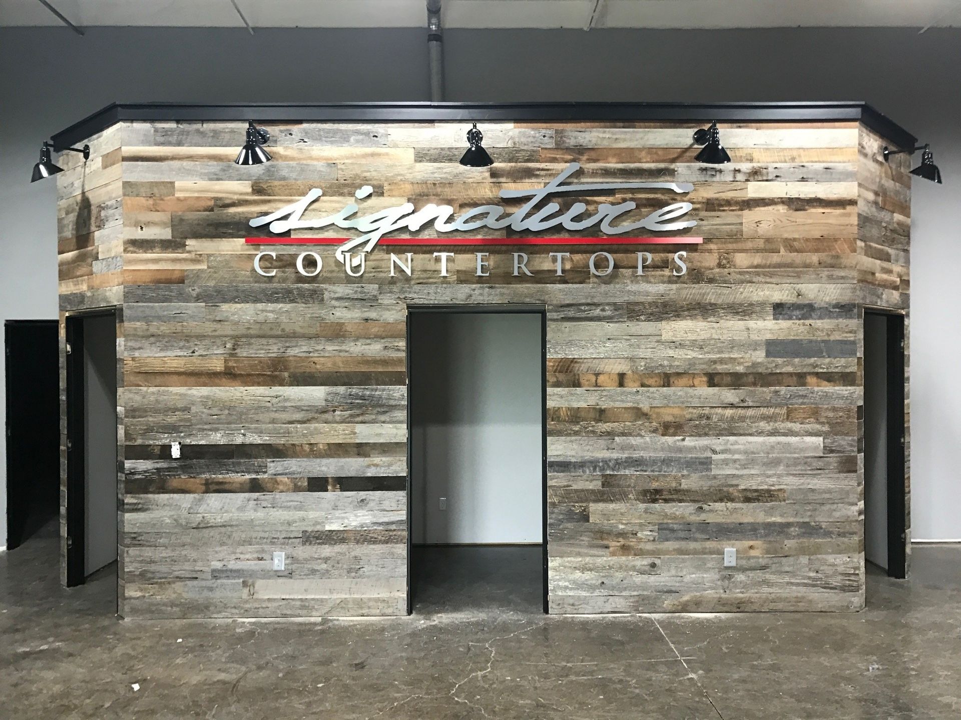 A wooden wall with signature countertops written on it