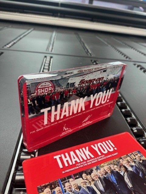 A thank you card is sitting next to a thank you block