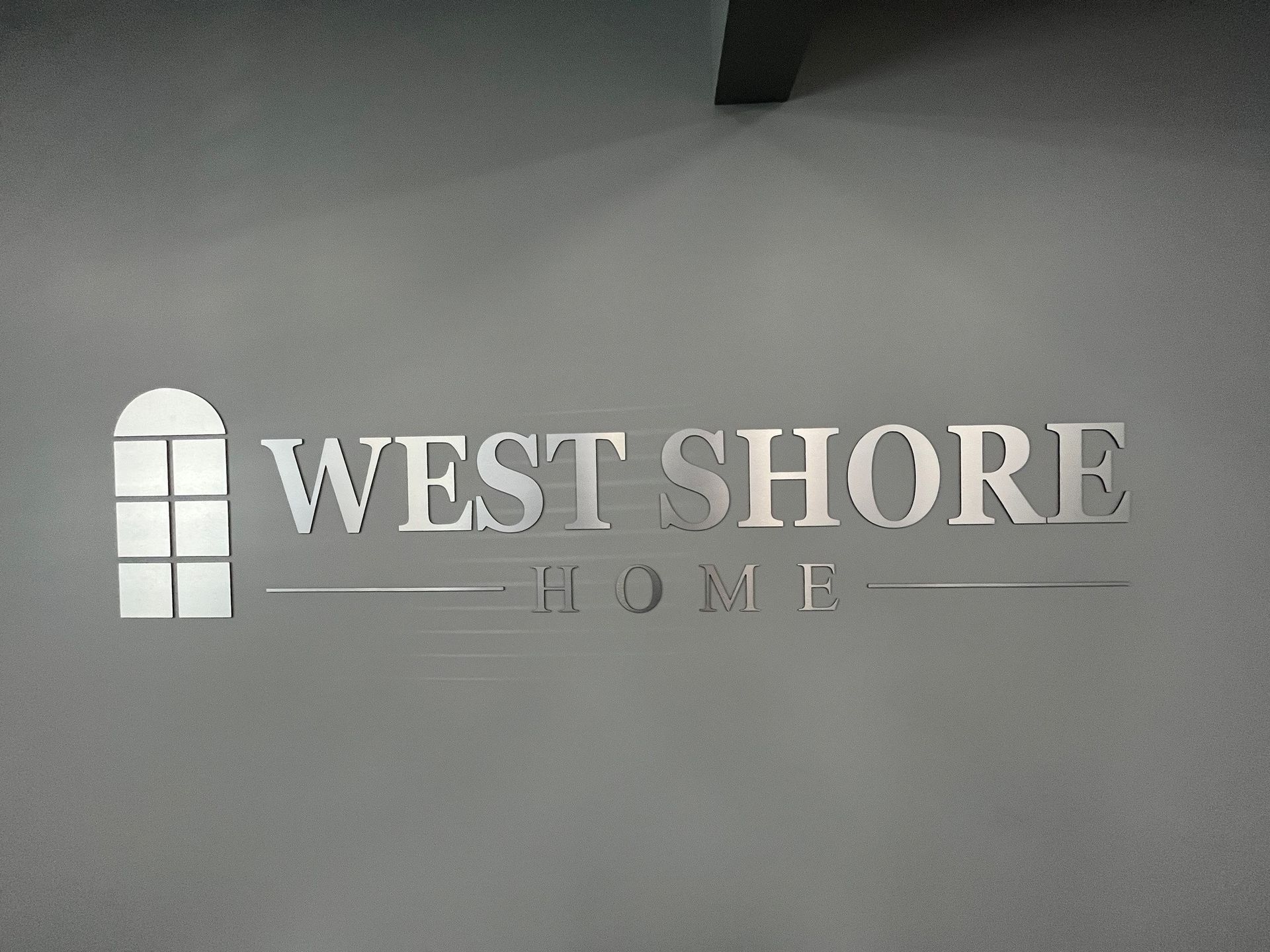 A sign that says west shore home on it