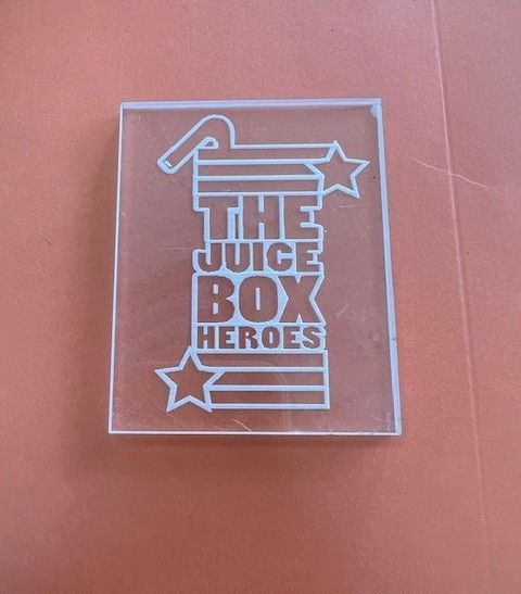 Clear acrylic plaque engraved with a graphic of a juice box, stars, and the text