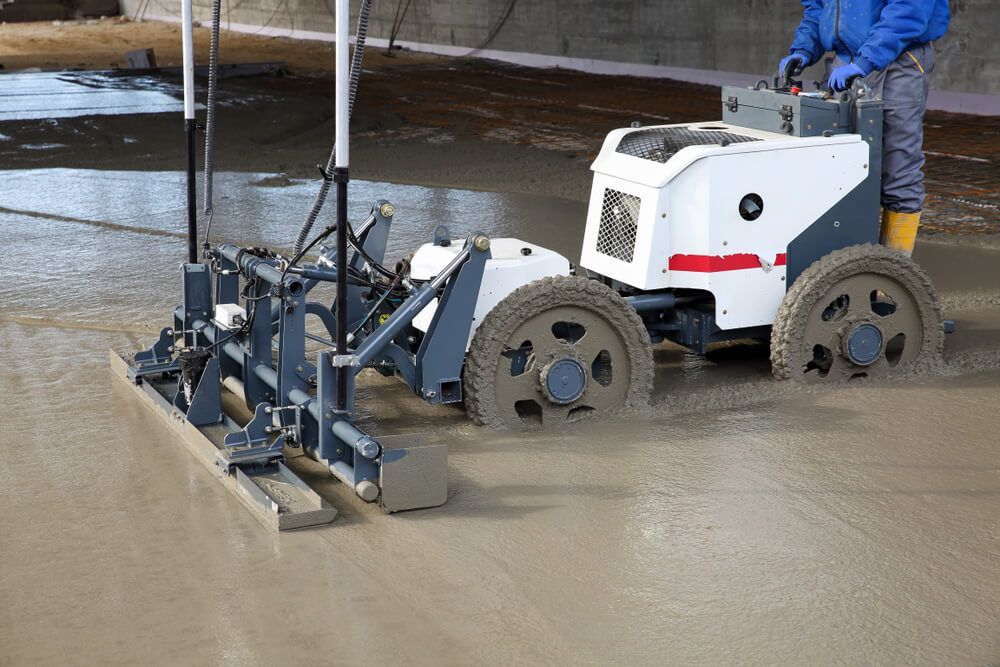 A Man is Driving a Machine on a Concrete Floor — C R Concreting in Leyburn, QLD