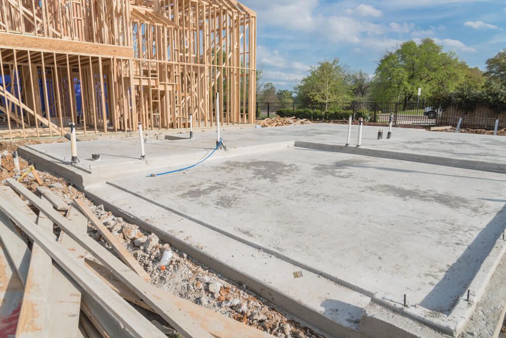 A House is Being Built With a Concrete Foundation and a Wooden Frame — C R Concreting in Highfields, QLD