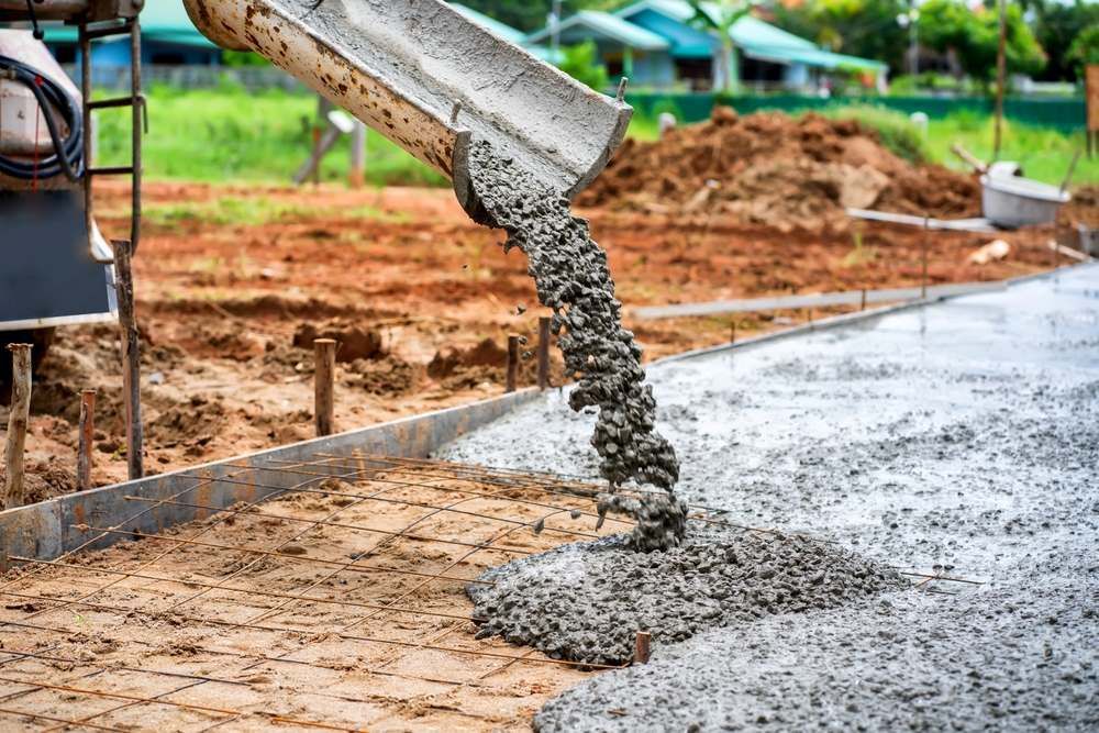 A Concrete Truck Is Pouring Concrete On A Construction Site — C R Concreting in Goondiwindi, QLD