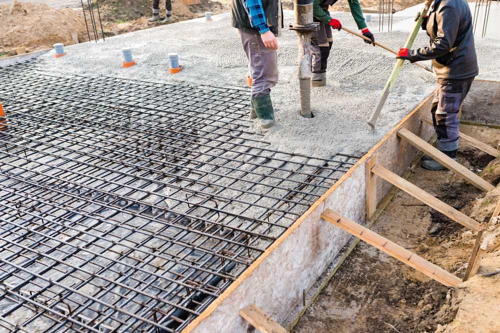 Construction Workers Pouring Concrete Into A Foundation — C R Concreting in Roma, QLD
