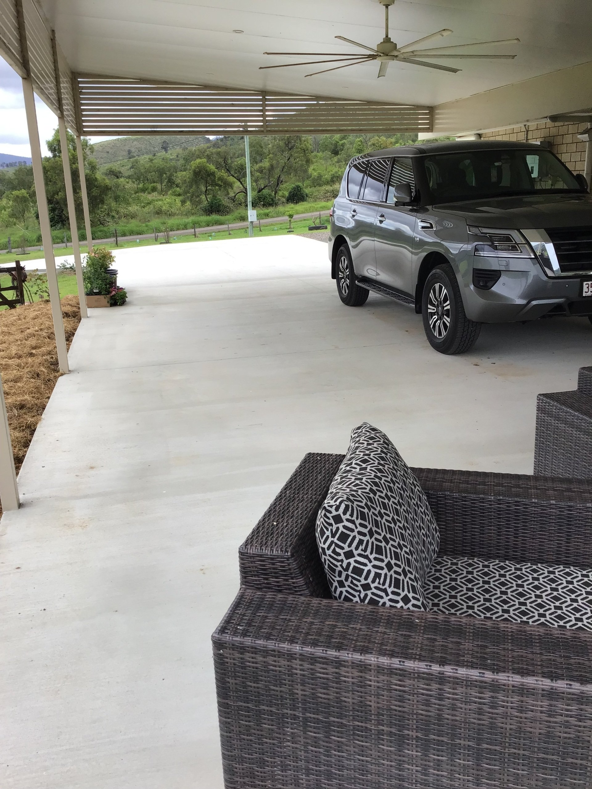 A Car is Parked Under a Canopy in a Driveway — C R Concreting in Pittsworth, QLD