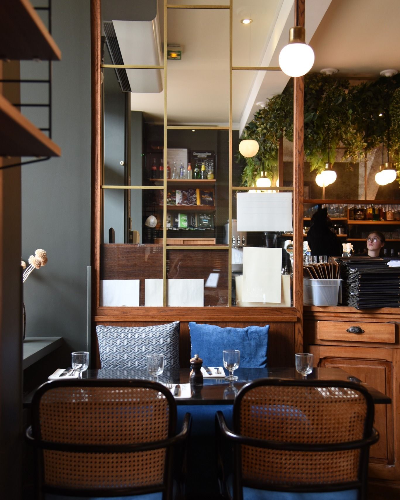 Un restaurant avec des chaises en osier et un miroir