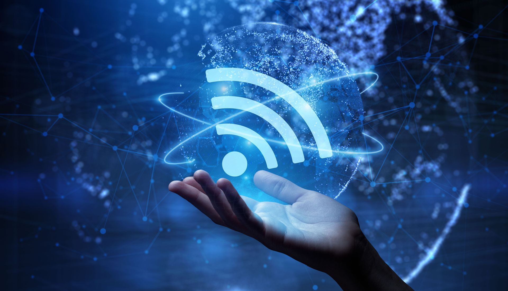 Hand holding glowing Wi‑Fi symbol over a blue digital network background