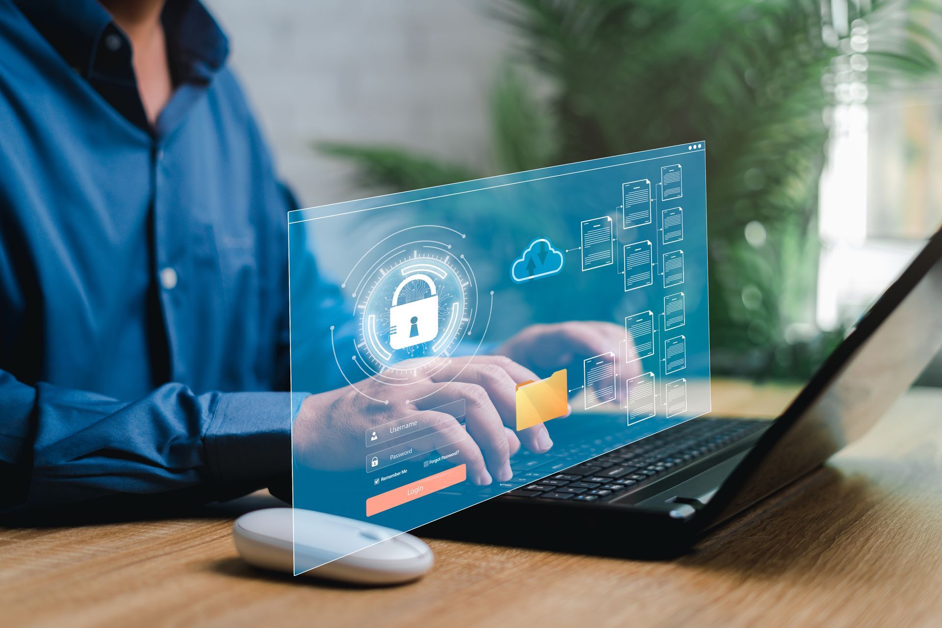 Person typing on a laptop beside a blue cybersecurity lock interface on a desk