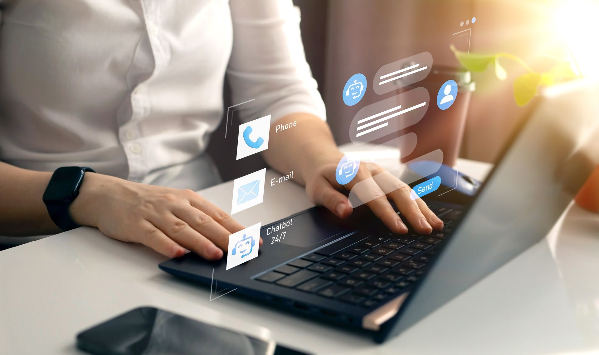 Hands typing on a laptop with digital interface icons floating above the keyboard.
