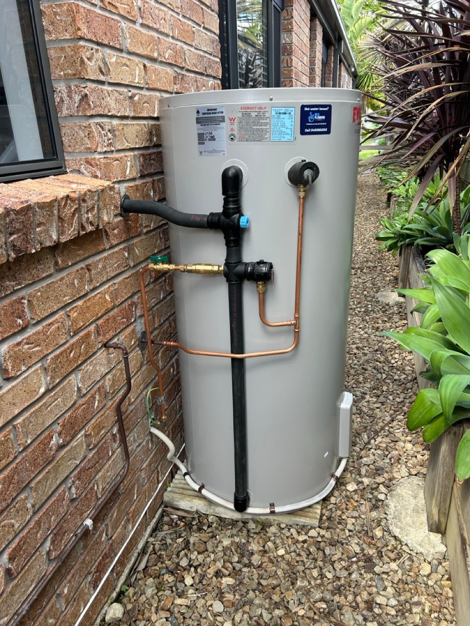 Copper Plumbing Pipes Installed in a Dirt Trench Beside a Brick Wall — No.2 Plumbing In Kenmore, QLD