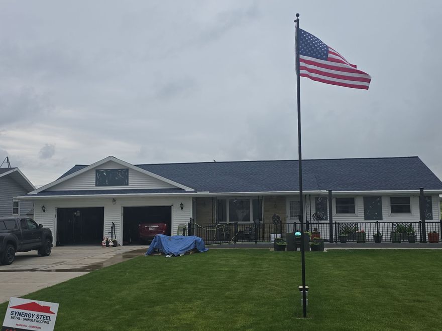 The roof of a house is being painted white.