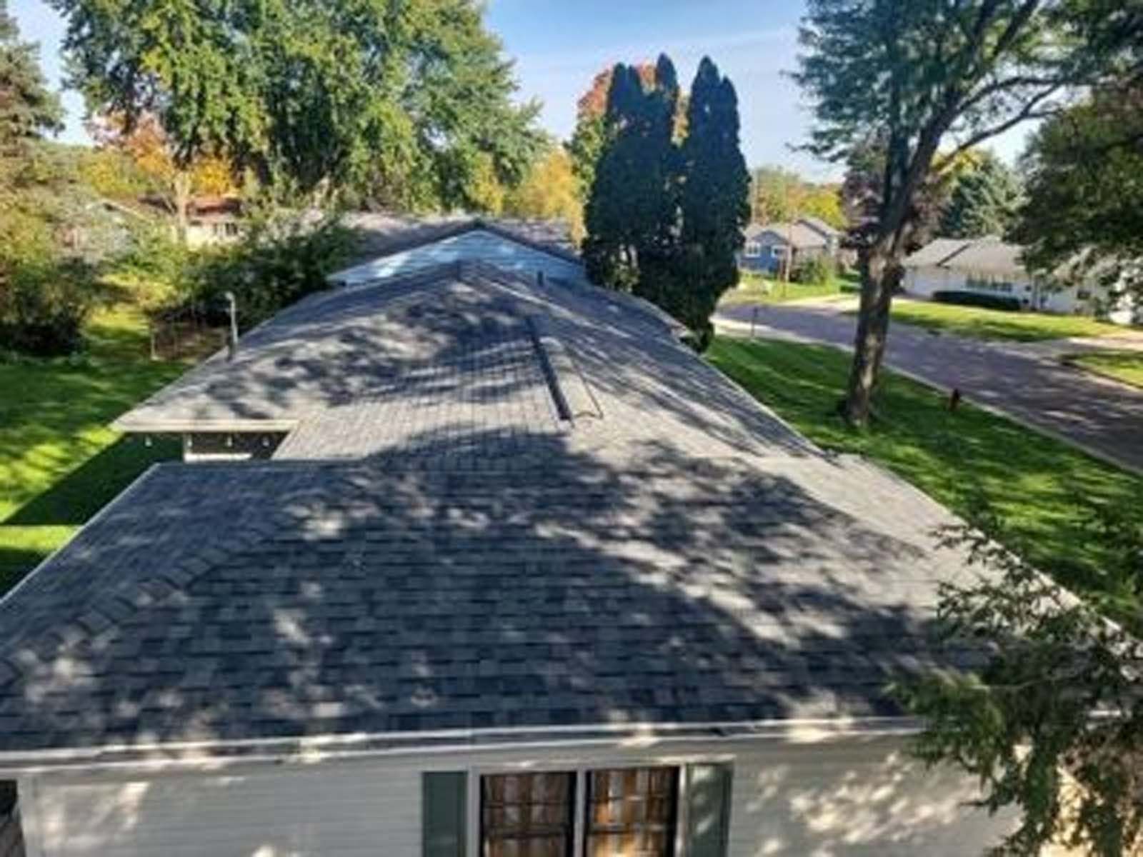 An aerial view of a house with a new roof.