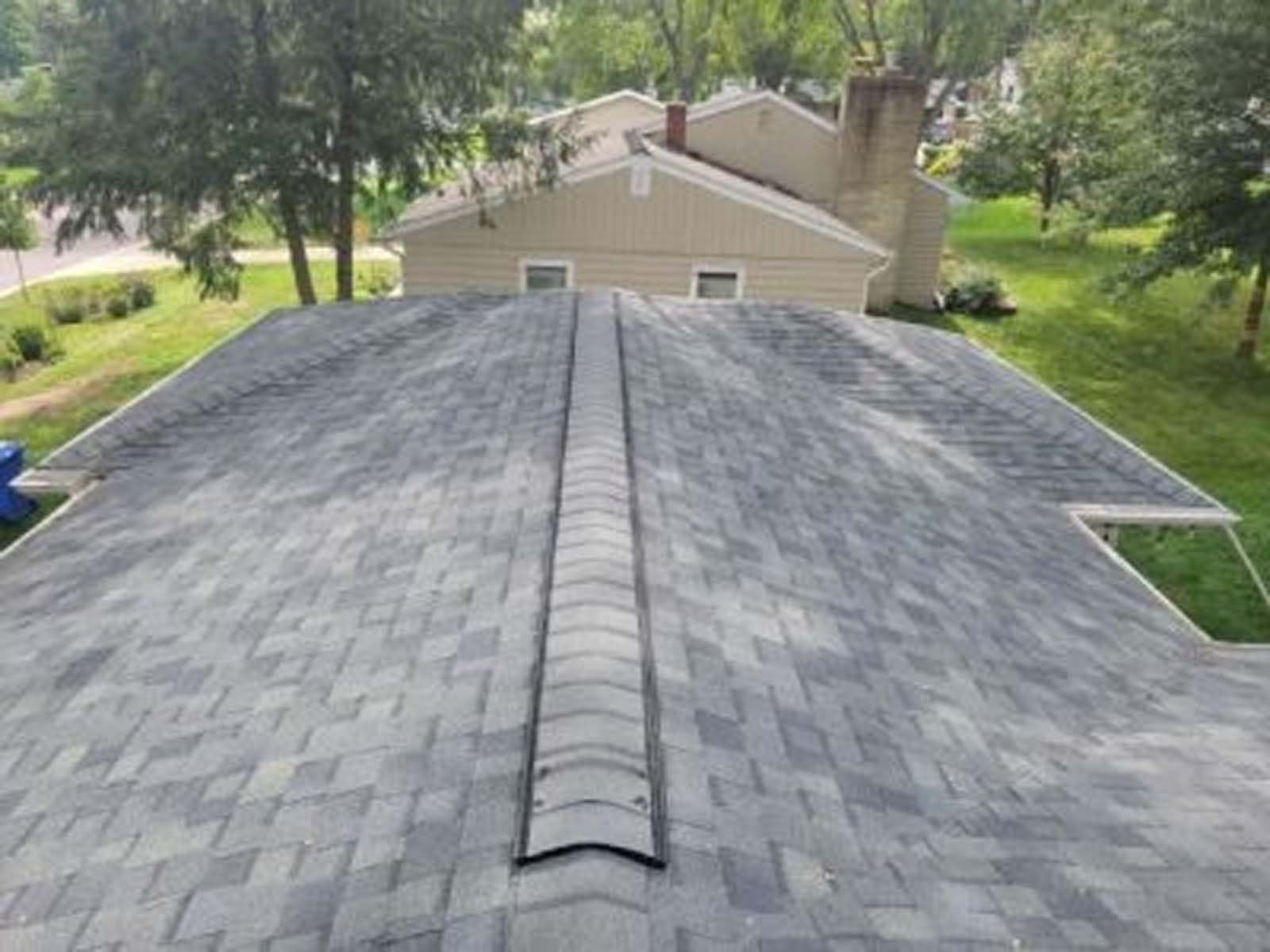 The roof of a house with a roof ventilator on it.