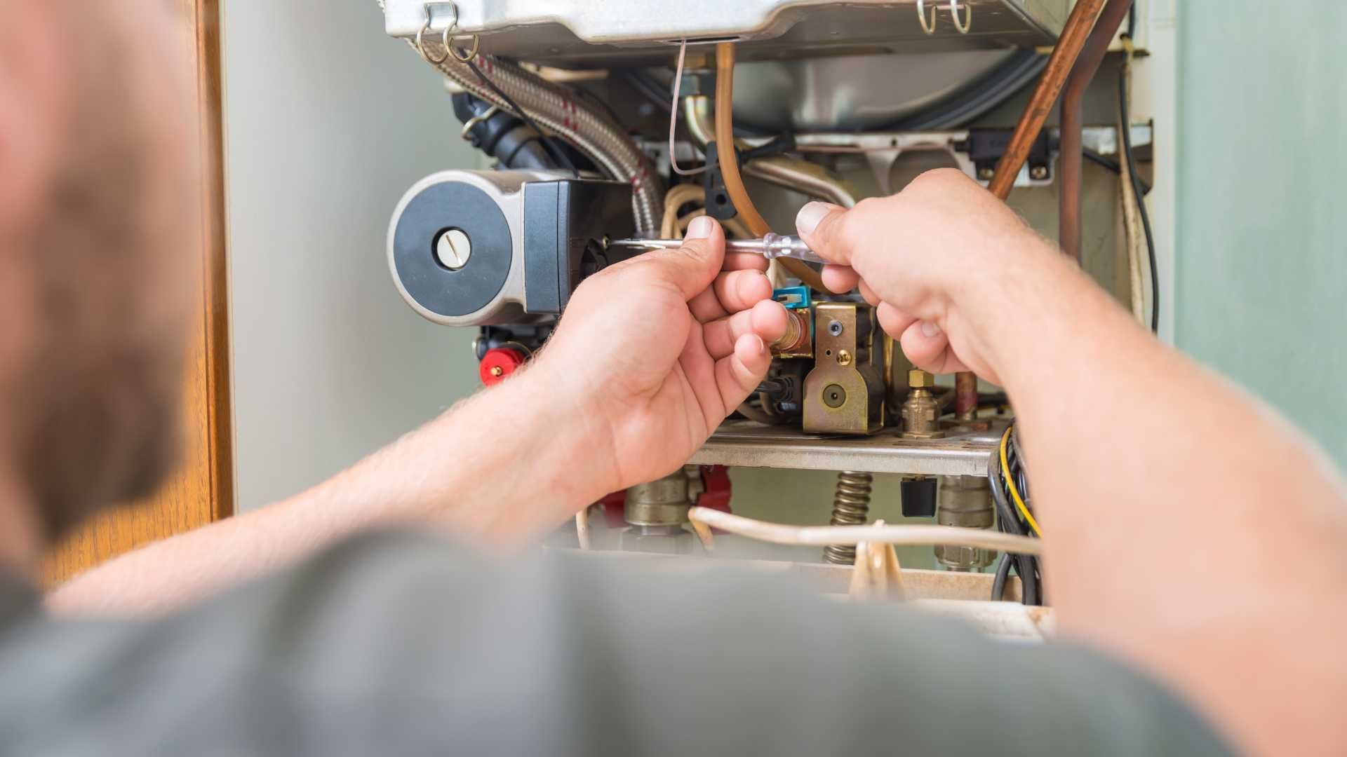 A man is fixing a furnace