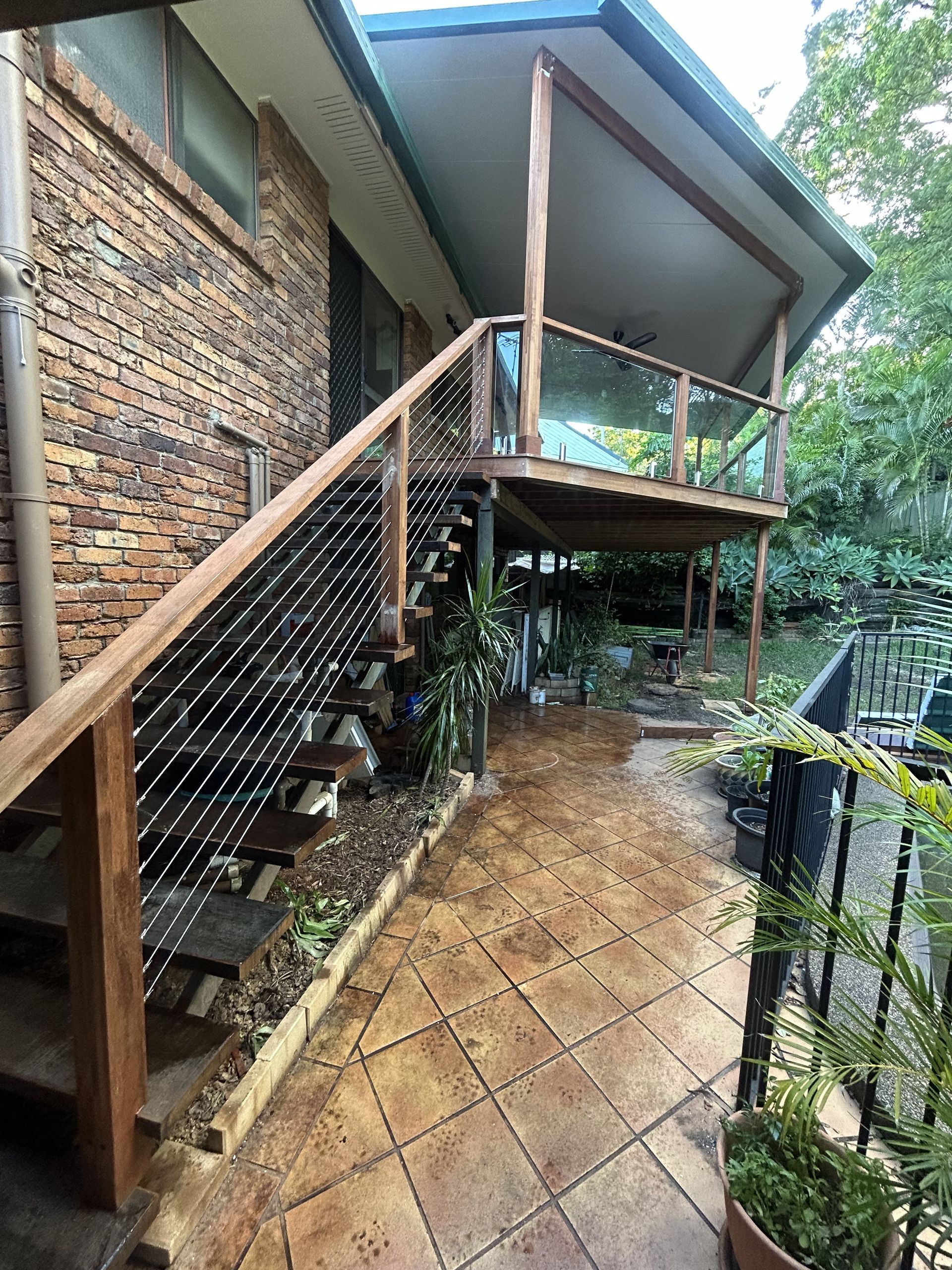 Outdoor Staircase Beside a Brick House With Tiled Patio — Jordan Building & Construction Pty Ltd in Ascot, QLD