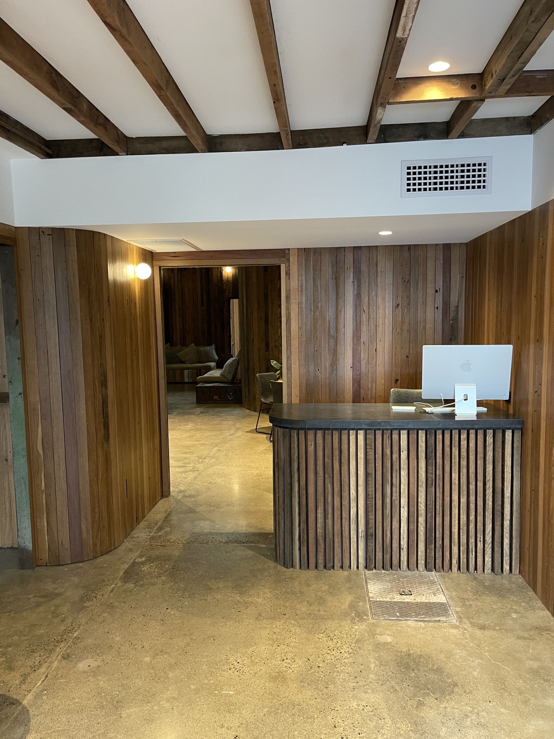 Wood-paneled Reception Desk in a Rustic Interior Hallway — Jordan Building & Construction Pty Ltd in Ascot, QLD