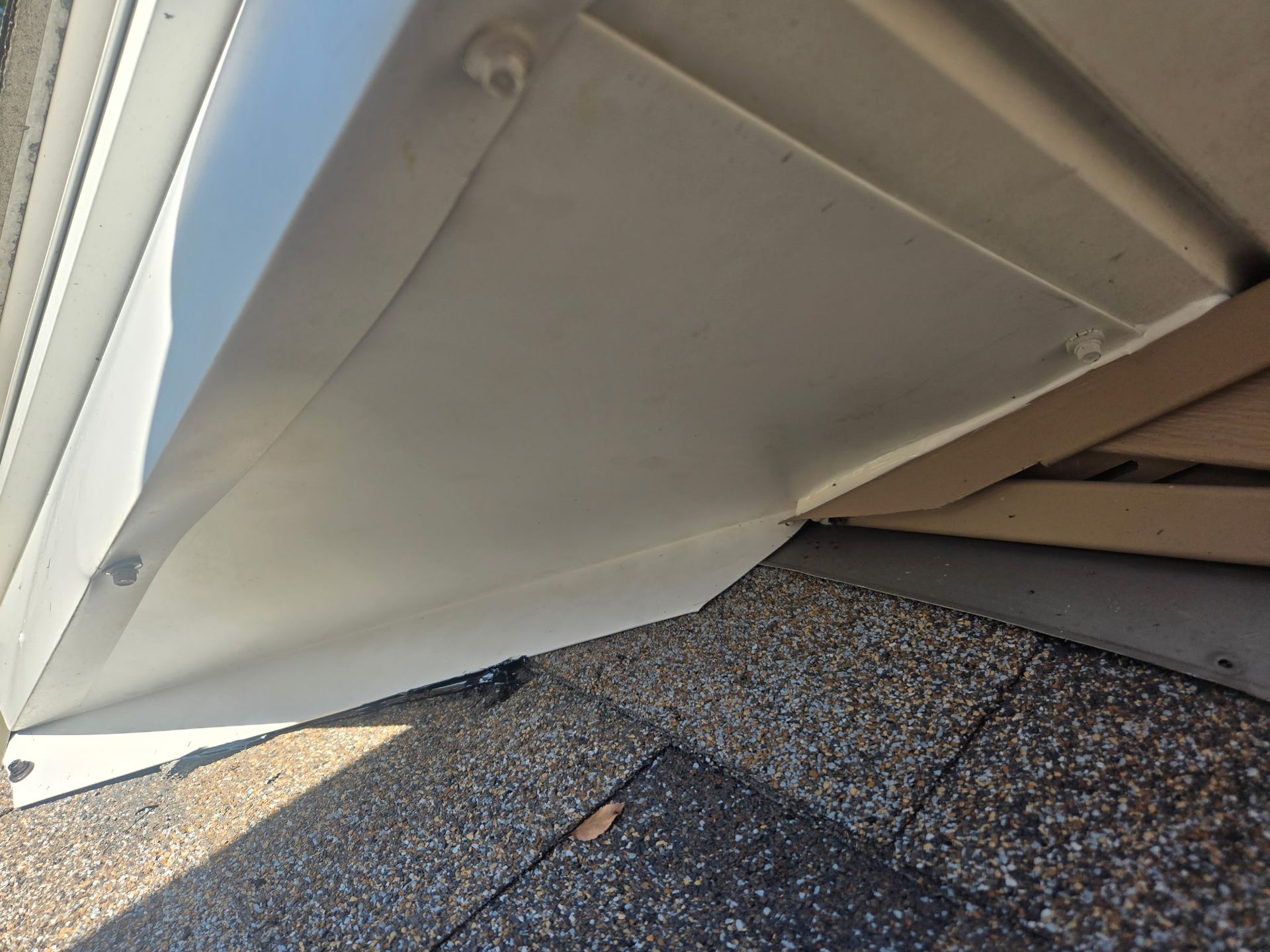 Soffit return in Roscoe, IL sealed with a custom-bent metal panel and sealant along the shingles to prevent animal entry.