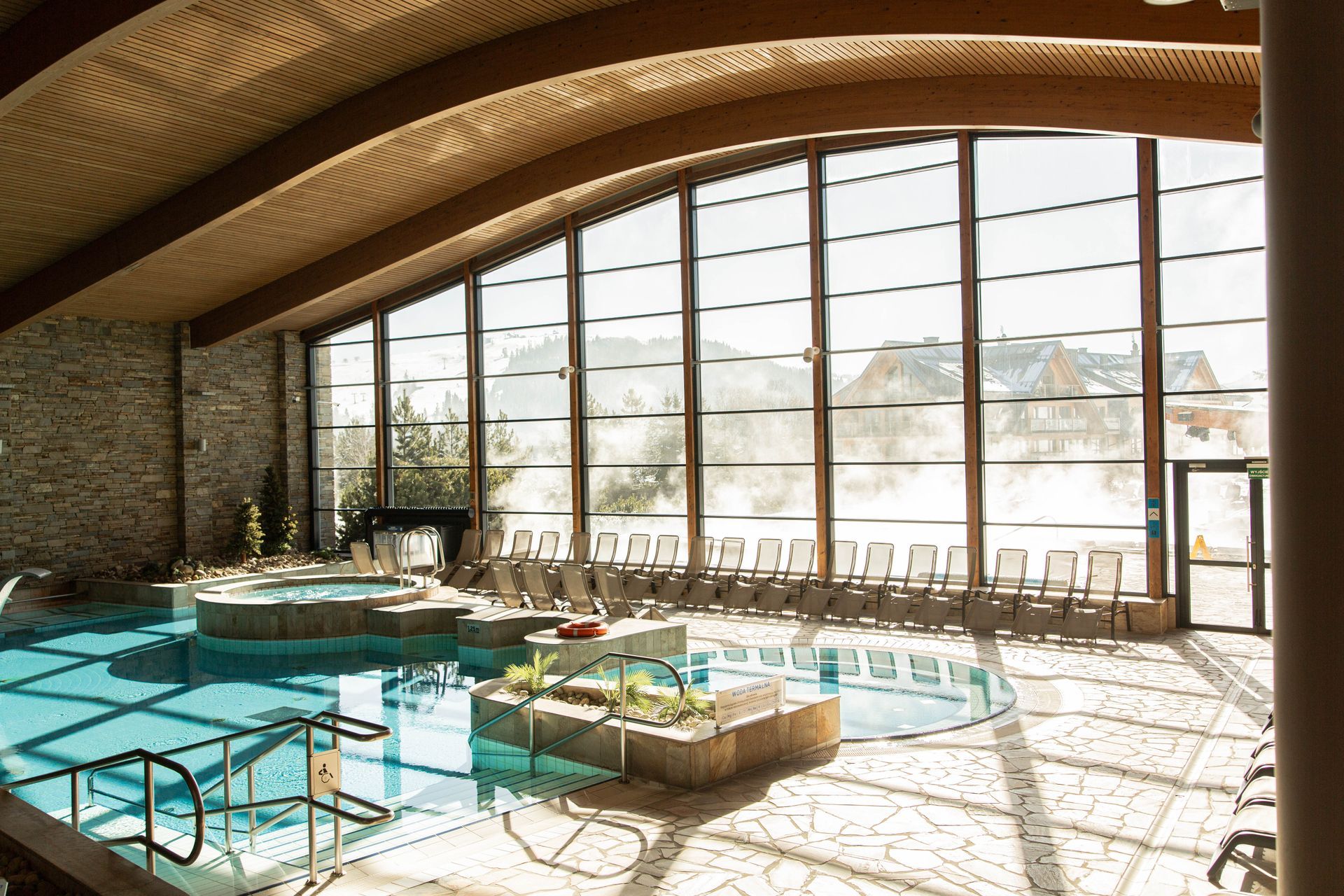 Indoor thermal pool with panoramic windows at Terma Bania