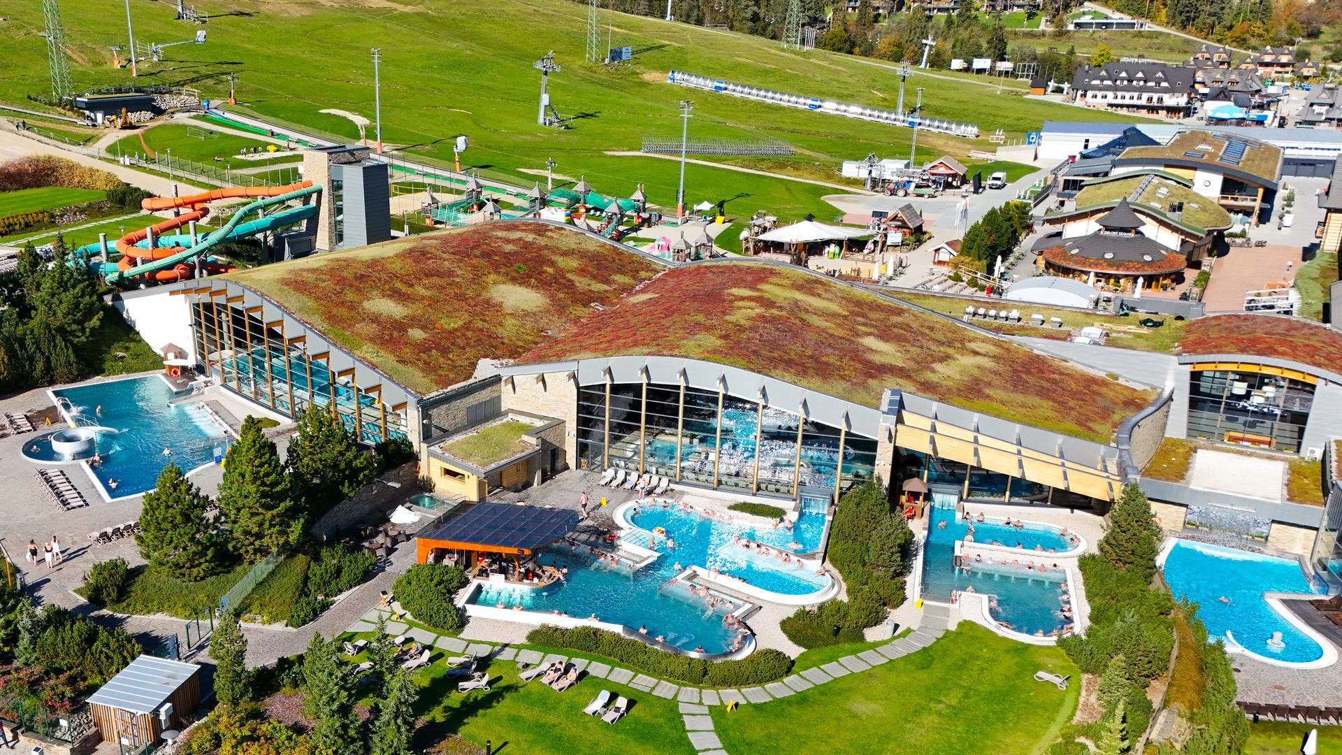Aerial view of Terma Bania with outdoor pools and water slide towers in Białka Tatrzańska