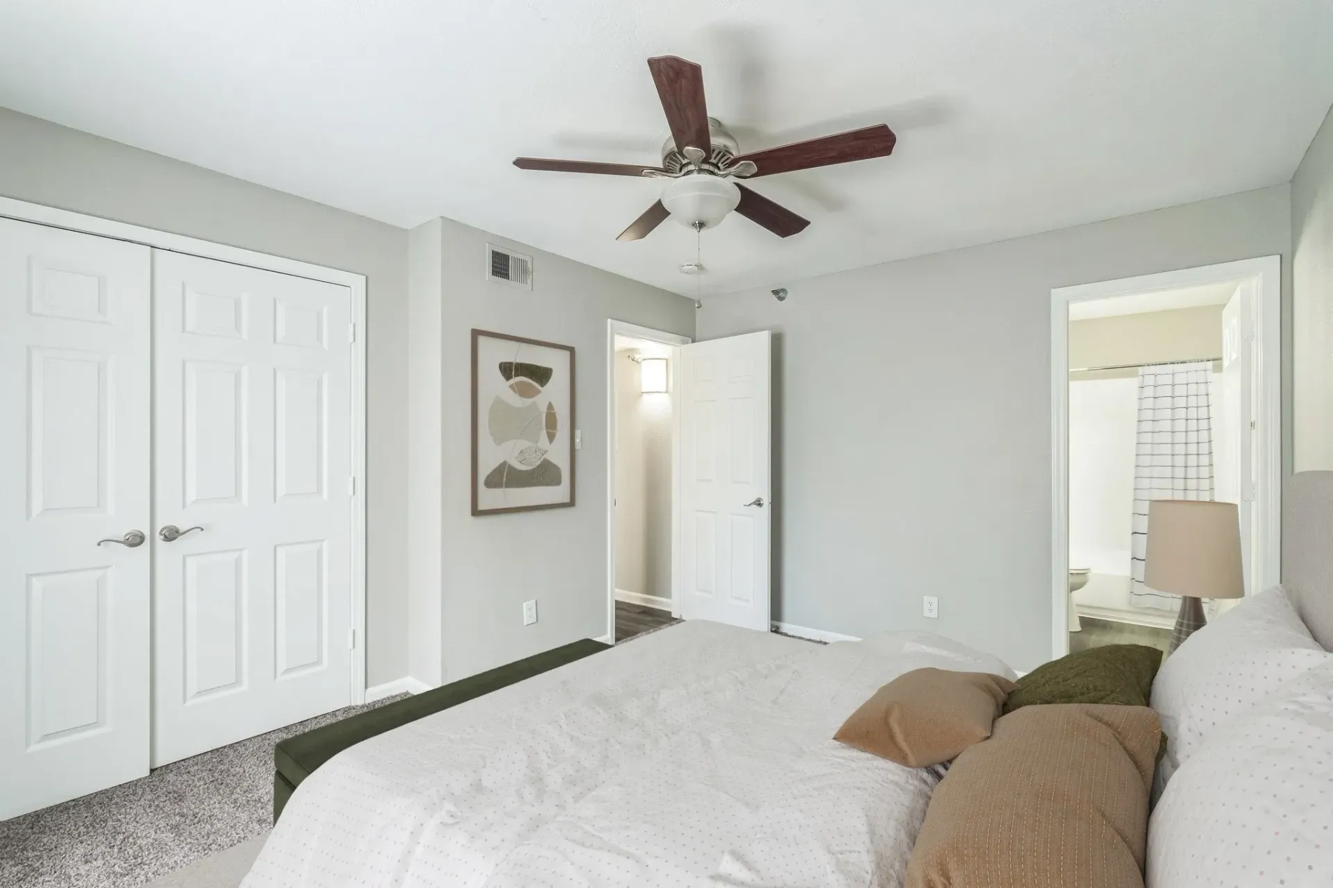 Photo of a master bedroom with a ceiling fan