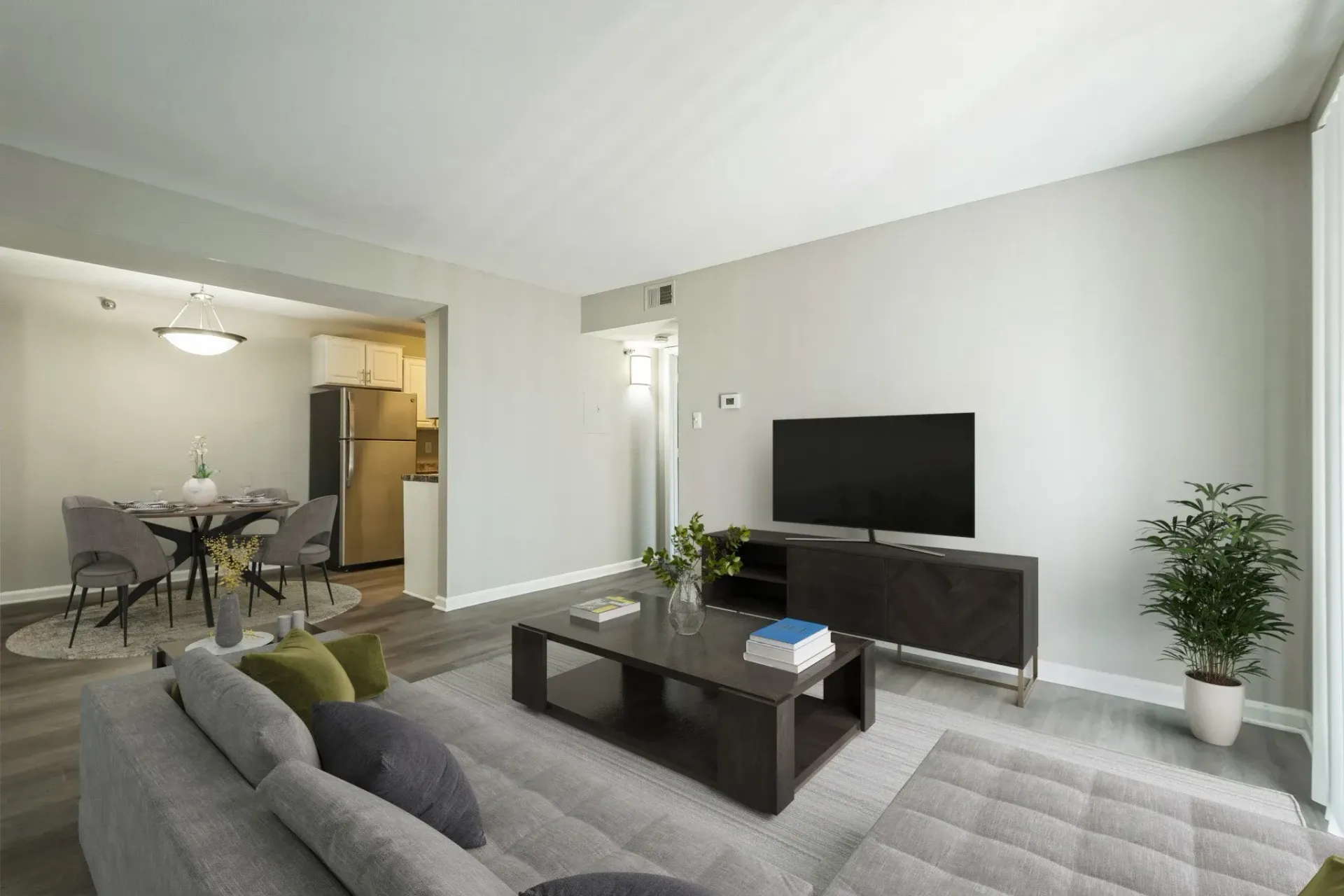 Photo of a living room with the dining room in the background, as well as the entrance to the kitchen