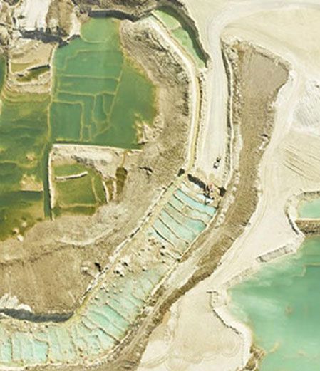 An aerial view of a large body of water surrounded by fields.