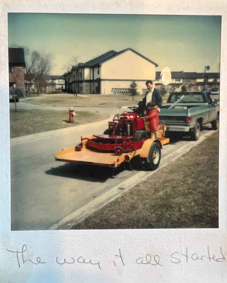 A picture of a man driving a lawn mower with the words